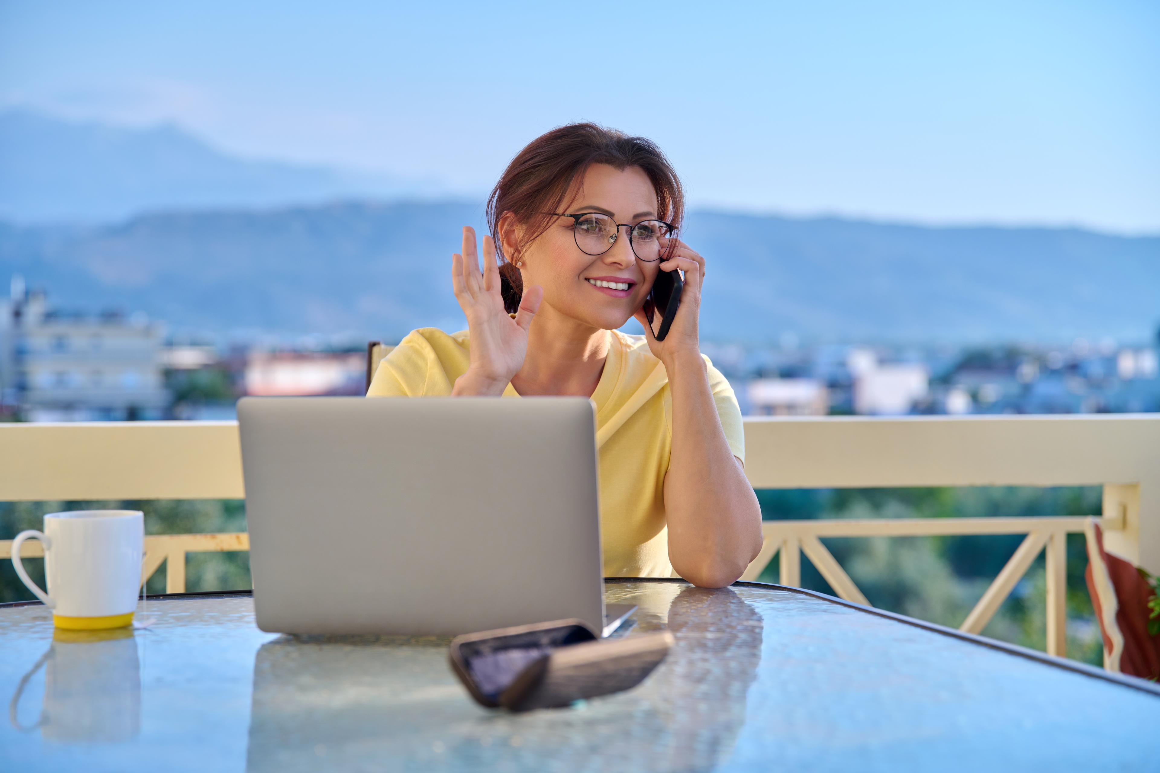woman-working-home-terrace-with-laptop-smartphone